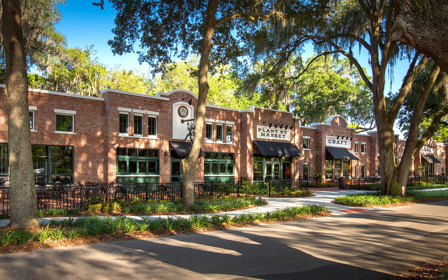 Plant Street Market in Winter Garden, Florida, showcasing brick architecture, outdoor seating, and greenery, relevant to local real estate insights.