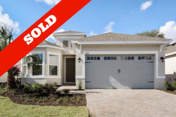 Pending-overlay-copy-11-768x509 Sold home in Four Seasons at Orlando, featuring modern architecture, landscaped front yard, and a prominent "SOLD" overlay.