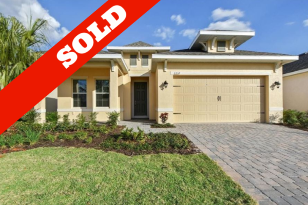 Pending-overlay-copy-30-600x400 Newly built home exterior with "SOLD" banner, showcasing modern architecture, landscaped front yard, and driveway, located in a desirable Central Florida community.