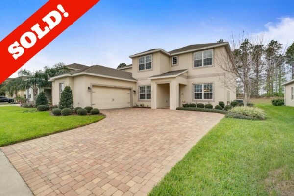 Sold home at 15522 Sandfield Loop, Winter Garden, featuring a spacious driveway, landscaped yard, and prominent "SOLD!" overlay.
