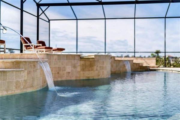 Resort-style pool with elegant water features and spacious lounging area at 11114 Romance Ct, Winter Garden, FL.
