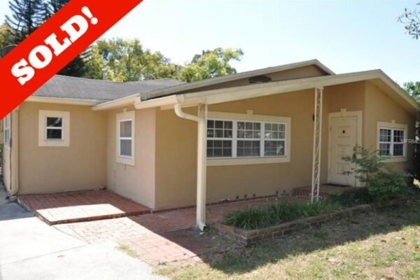 Sold property at 1006 Venetian Ave, Orlando, featuring a beige exterior, large windows, and a brick pathway, indicating recent sale status.