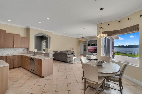Modern kitchen and living area in a lakefront home at 2039 Water Key Drive, Windermere, featuring a spacious open floor plan, natural light, and views of Lake Roberts.