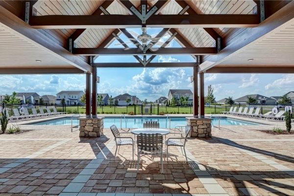 Community pool area with shaded seating, surrounded by residential homes in The Preserve at Turtle Creek, Saint Cloud, FL.