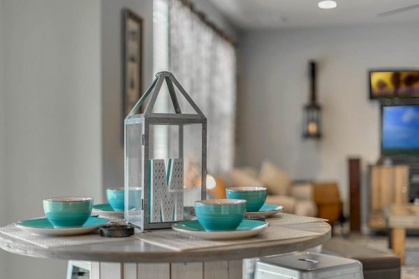 Stylish kitchen table setting with turquoise bowls and decorative lantern, showcasing a modern interior design in the home at 2989 Park Meadow Drive, Apopka, FL.