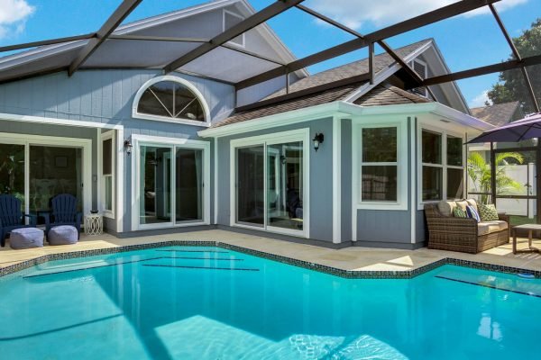 Screened pool area of a home at 633 Remington Oak Dr, Lake Mary, FL, featuring a spacious layout, modern design, and outdoor seating, emphasizing privacy and tranquility with views of a conservation area.