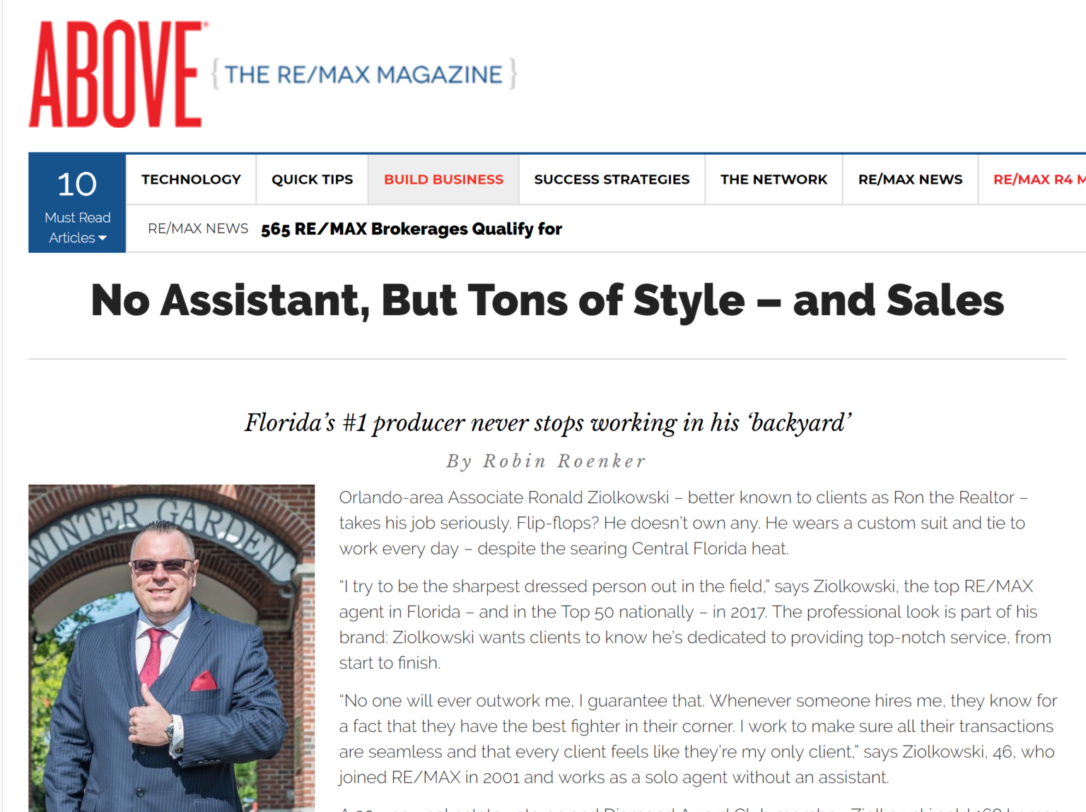 Ronald Ziolkowski, a top RE/MAX real estate agent in Florida, wearing a custom suit and tie, smiling confidently in front of a brick building, representing personal dedication and exceptional customer service in real estate.