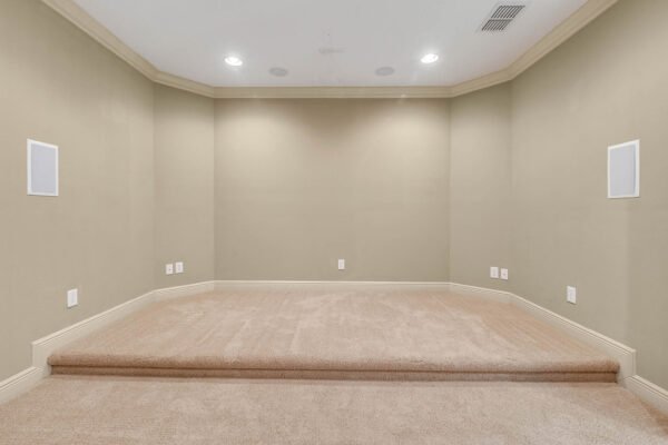 Bonus room with carpeted flooring, recessed lighting, and built-in speaker system, designed for entertainment or leisure in a luxury lakefront home at 1837 Lake Roberts Landing Dr, Winter Garden, FL.