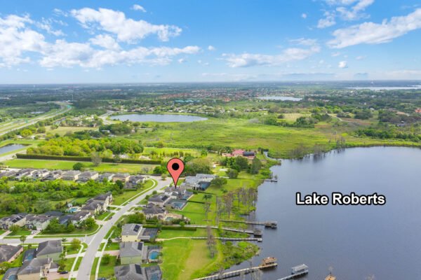 Aerial view of Lake Roberts in Winter Garden, FL, highlighting nearby residential properties and the location of 1837 Lake Roberts Landing Dr, with a marker indicating the property’s position near the lakefront.
