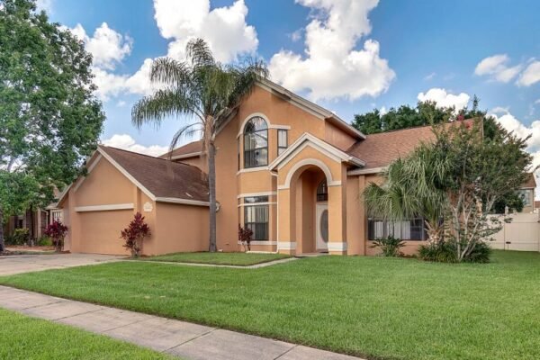 12847-sharp-shined-street-orlando-fl-32837-02-768x513-1-600x400 Two-story home at 12847 Sharp Shined Street in Orlando, FL, featuring a large fenced yard, palm trees, and bright exterior under a blue sky with clouds.