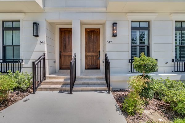 Entrance of brownstone units at 641 and 647 E Jackson St, Orlando, showcasing modern architecture, wooden doors, and landscaped surroundings, reflecting luxury living in downtown Orlando.