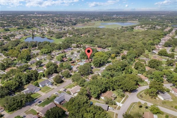 Aerial view of a residential neighborhood in Orlando, Florida, featuring homes, green spaces, and a marked location pin indicating 7822 Hyacinth Dr, highlighting proximity to sought-after schools and expressways.