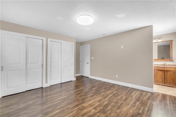 Spacious interior of a remodeled home featuring hardwood floors, modern lighting, and double closet doors, ideal for showcasing updated living spaces in the Windermere real estate market.