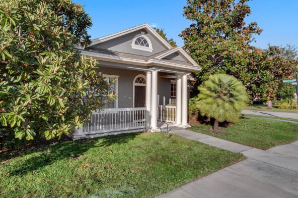 12945-overstreet-road-windermere-fl-34786-01-scaled-600x400 Exterior view of 12945 Overstreet Rd, a one-story home in Windermere, FL, featuring a front porch, landscaped yard, and nearby palm tree, highlighting desirable community living.