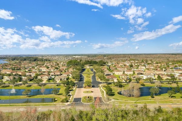 Aerial view of a residential community in Winter Garden, Florida, featuring well-maintained homes, landscaped parks, and serene lakes, highlighting the desirable neighborhood amenities near 592 First Cape Coral Dr.