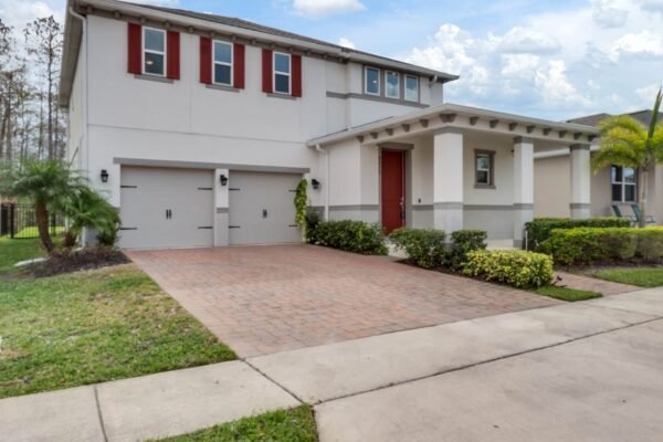 8073-bowery-drive-winter-garden-fl-34787-02-1536x1152-1-600x400 Modern two-story home at 8073 Bowery Drive in Winter Garden, featuring a brick driveway, red shutters, and lush landscaping, highlighting its curb appeal and proximity to conservation area.
