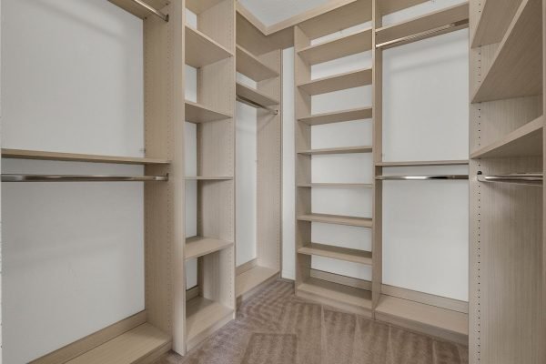 Custom walk-in closet with ample shelving and hanging space, designed for organization and storage in a Winter Garden home.