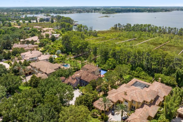 Aerial view of luxury homes in Windermere, FL, showcasing the expansive property at 11019 Bridge House Road, surrounding lush greenery, and proximity to Lake Butler.