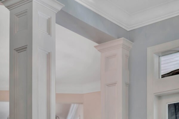 Elegant interior columns and crown molding in a luxury home, highlighting architectural details and design sophistication in Windermere, FL.