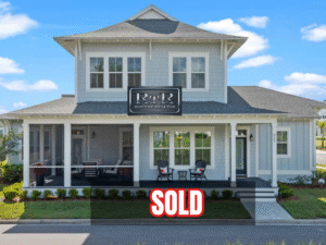 Sold residential property featuring a modern two-story home with a porch, RTR Orlando branding, and bright blue sky in the background.