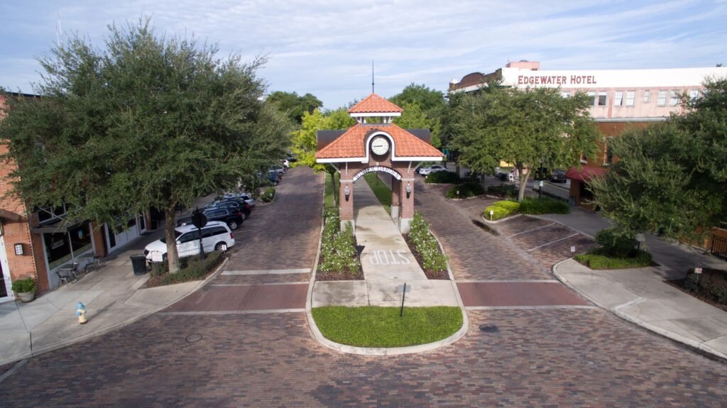 Winter Garden street view featuring a decorative archway, surrounding shops, and the Edgewater Hotel in the background, highlighting the local real estate market context.