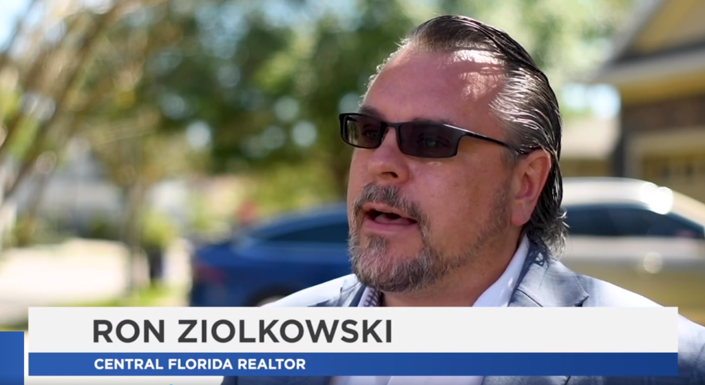 Ron Ziolkowski, Central Florida realtor, speaking outdoors, showcasing real estate expertise amidst residential backdrop.