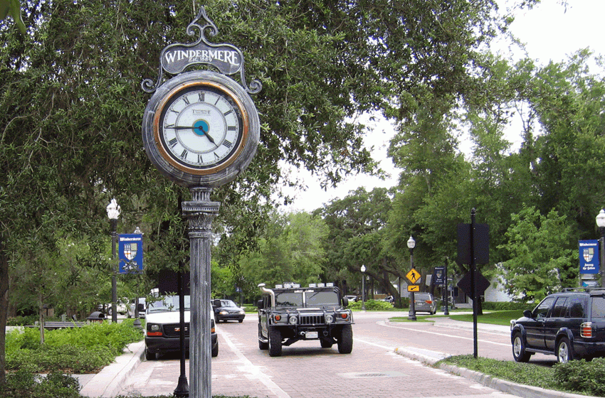 Windermere town clock in Florida, surrounded by greenery and vehicles, highlighting the local atmosphere relevant to Windermere's community and budgetary discussions.